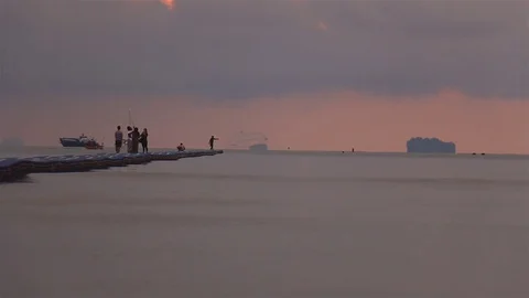 Group of friends on foating walkway at sunrise. Stock Footage 70881237