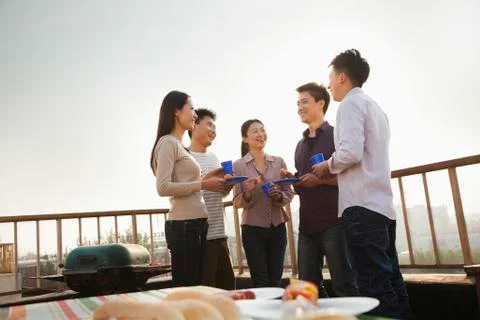 Group of Friends Having a Barbeque on a Rooftop Stock Photos