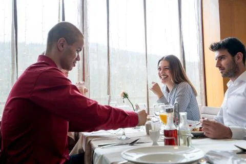 Group of friends having dinner Stock Photos
