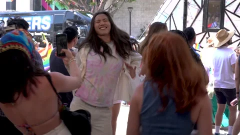 Group of friends having fun and dancing to a DJ at the Los Angeles Pride Parade 動画素材 197177603
