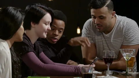 A group of friends having fun at a bar with a cell phone 스톡 동영상 62692289