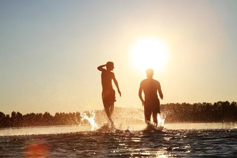 Group of friends having fun on the beach. Stock Photos