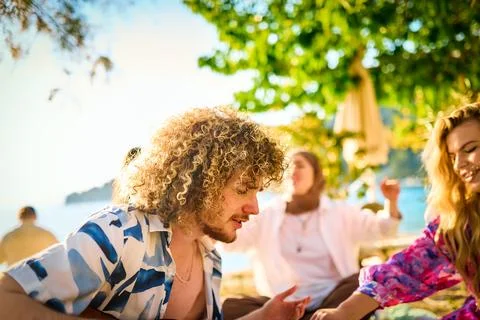 Group of friends having fun on the beach Stock Photos