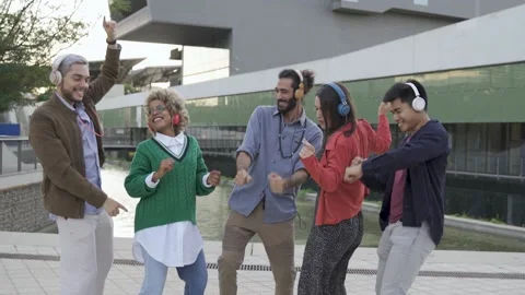 Group of friends having fun dancing to music together outdoor Stock Footage 168712961