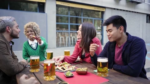 Group Of Friends having fun Enjoying Evening Drinks and food In Bar. Happy Stock Footage 166864018