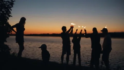 A group of friends having fun with fireworks or Bengal lights. Stock Footage 79792997