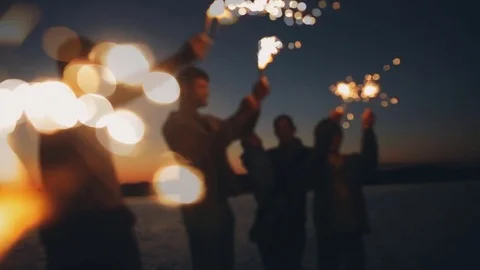 A group of friends having fun with fireworks or Bengal lights. Stock Footage 79793210