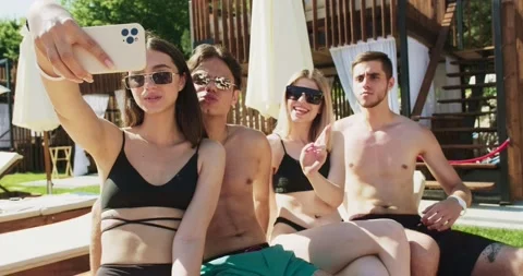 Group of friends having fun at pool. Taking selfie on smartphone sitting Video stock 158216289