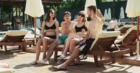 Group of friends having fun at pool. Taking selfie on smartphone sitting Stock Footage 158374251