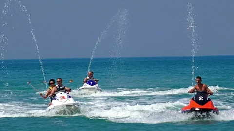 Group of friends having fun riding a jetski into the blue ocean Stock Footage 88323081