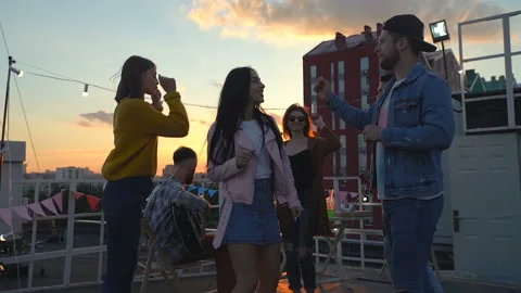 Group of friends having fun at the rooftop party. Dancing and enjoying life. Video stock 110701796