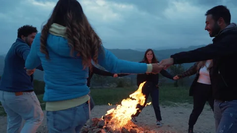 Group of friends having fun together at night party around bonfire - Friendship Stock Footage 224691899