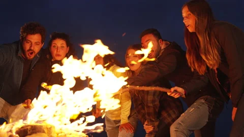 Group of friends having fun together at night party around bonfire - Friendship Stock Footage 224692508
