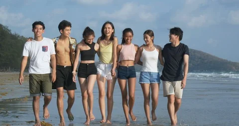 Group of Friends having fun walking down the beach with happy emotion. Stock Footage 104071842