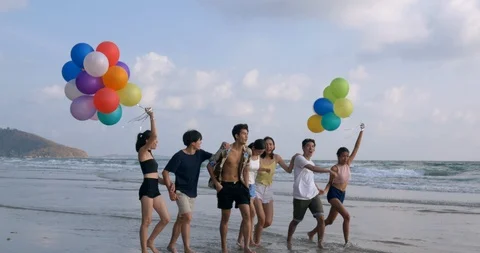 Group of Friends having fun walking down the beach. Stock Footage 104095308