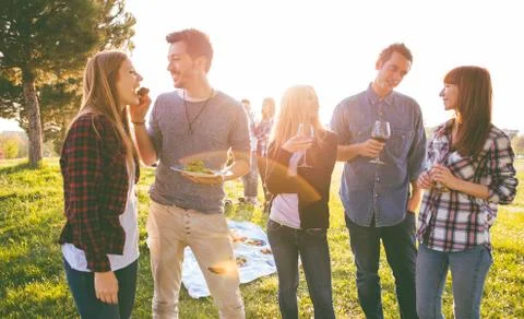 Group of friends having fun while eating and drinking at a pic-nic - Happy .. Stock Photos