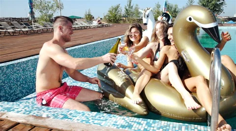 Group Of Friends Having Party In Pool Drinking Champagne. 20s. 1080p Slow Motion Stock Footage 65829082