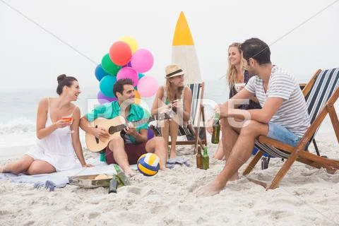 Group Of Friends Having A Small Party On The Beach