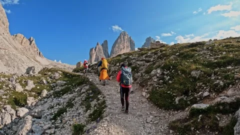Group of friends hiking trail path and climbing Tre Cime di Lavaredo Dolomites Stock-Footage 248389336