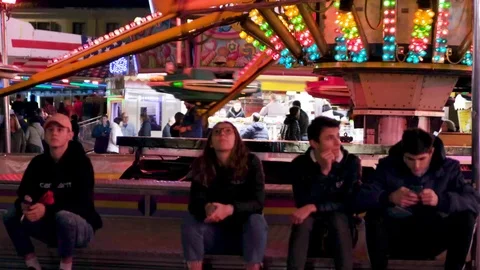 Group of Friends looking Up Carousel Airplane Ride In Night Park Stock Footage 121418708