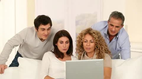 Group of friends looking at laptop computer Stock Footage 14832488