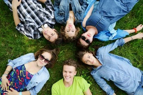 Group of friends lying on meadow 스톡 사진