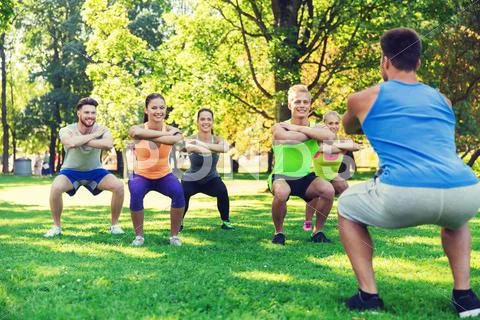 Group of friends or sportsmen exercising outdoors Stock Photos