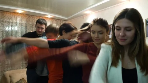 Group of friends perform the 'dabbing' dance move at home. Friends make the arms Stock Footage 83682360