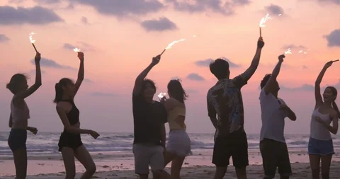Group of Friends playing firework together with sunset background. Stock Footage 104096824
