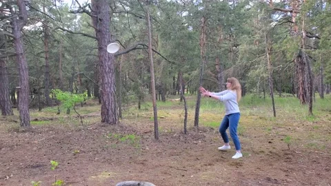 Group of friends playing flying disc in beautiful pine forest, leisure, outdoor Video stock 134972295
