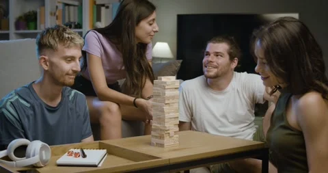 Group of friends playing Jenga together Stock Footage 297789519