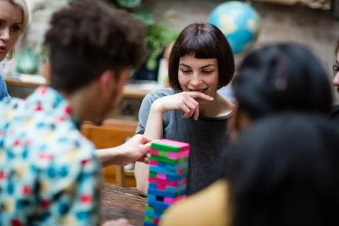 Group of friends playing retro game in pub Stock Photos