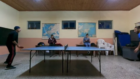 Group of Friends Playing Table Tennis Ping Pong Game Indoors with Spectators Stock Footage 328337113