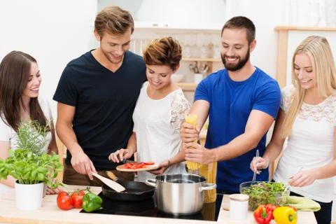 Group of friends preparing dinner Stock Photos
