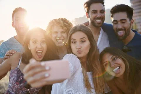 Group of friends pulling faces to selfie together Stock Photos