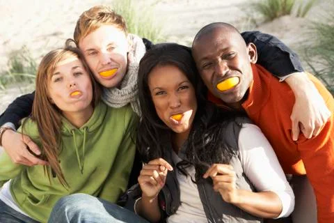 Group of friends pulling funny faces on beach Stock Photos