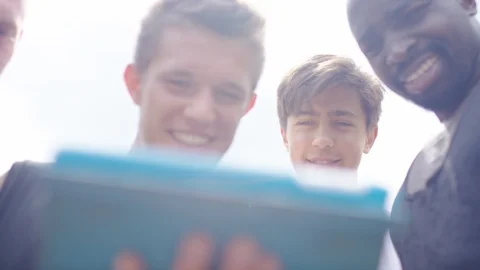 Group of friends react to something they're watching on a digital tablet Stock Footage 91580955