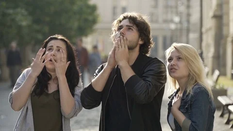 Group of friends reacting to something strange they see up high in the sky Stock Footage