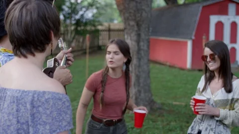 A group of friends sing-along at a backyard party in the summer Video stock 116879144