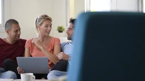 Group of friends sitting in couch websurfing on internet Stock Footage