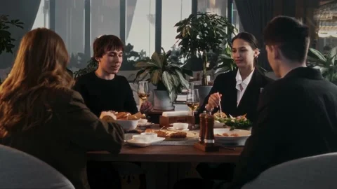 Group of friends sitting at table in restaurant Stock Footage 315010100