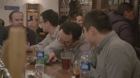 Group of Friends Socializing and Drinking at a Bar in Beijing, China at Night Stock Footage 345751174