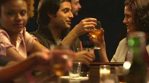 A group of friends spend time together drinking at a bar Video stock 33998607