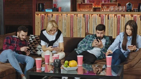 Group of friends spending a good time all together in a large spacious living Stock Footage 122845555