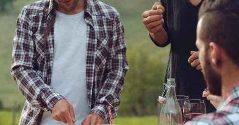 Group of friends spending time making a picnic and a barbeque. shot in slow moti Stock Footage 92469703