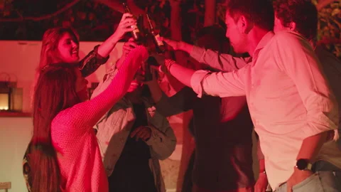 Group of friends standing in backyard, clinking bottles of beer Stock Footage 162259519