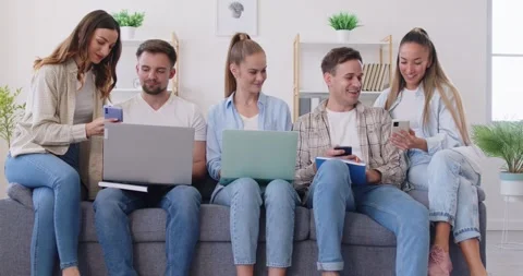 Group of friends, students or colleagues using laptops and smartphones, working Stock Footage 337391828