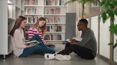Group of friends study materials in library Stock Footage 262755988