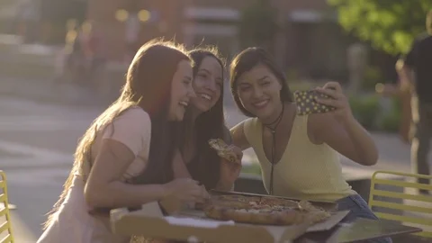 Group Of Friends Take Fun Selfies With Pizza, They Scroll Through The Photos Video stock 76855772