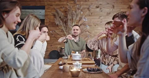 Group of friends takes small cups drinking beverage in cafe Video stock 197411055
